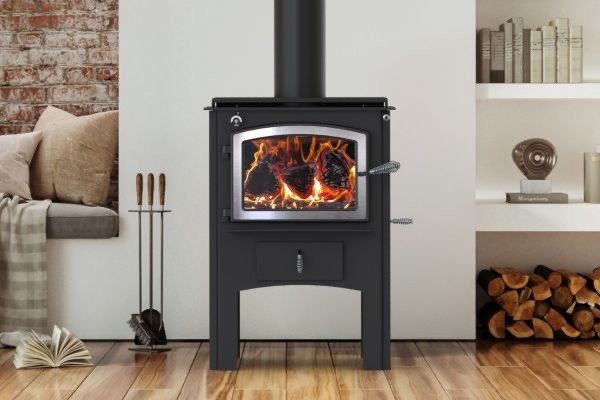 Black Kuma steel wood stove with fire burning in a bright modern room